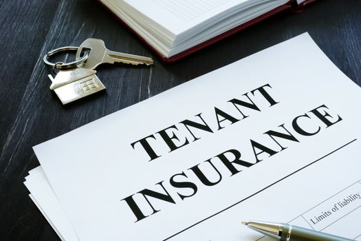 Tenant insurance policy, key and pen for signing.