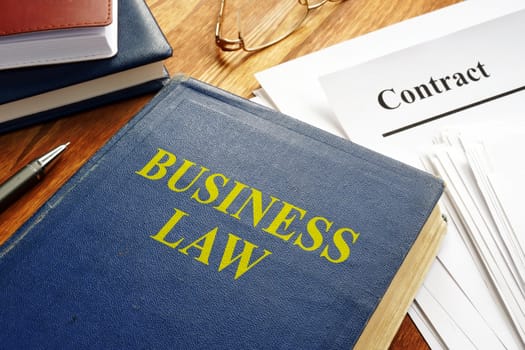 Business law book and corporate contract.