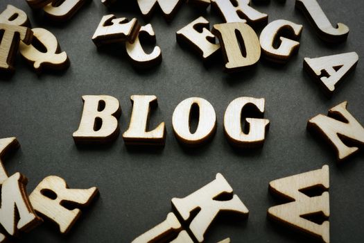 Blog and wooden letters on desk. Blogging concept.