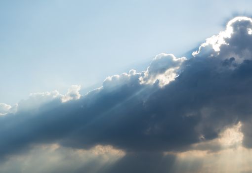 Sunbeam of the sun behind the clouds , sky background