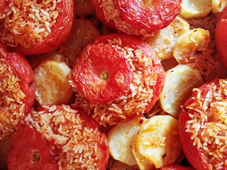 baked tomatoes with rice and potatoes. Typical recipe of the Roman culinary tradition. Italian food