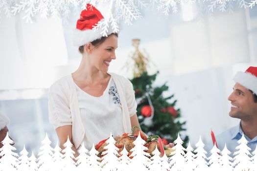 Cheerful woman wearing santa hat and bringing a roast chicken against fir tree forest and snowflakes