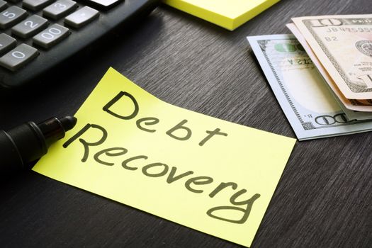 Debt Recovery sign with cash and calculator.