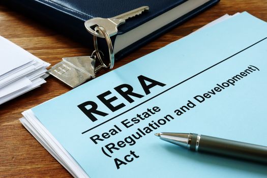 RERA or Real Estate Regulation and Development Act on the desk and key.