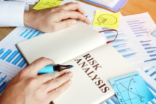 Businessman reads risk analysis report in the office.