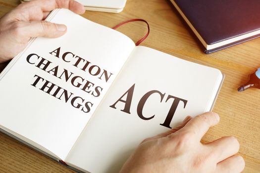 ACT - Action Changes Things words in the open book.