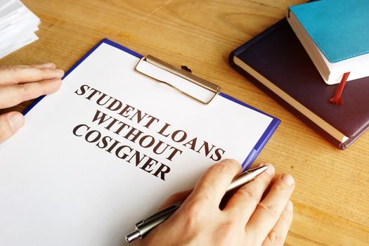 Man holding student loans without cosigner application form.
