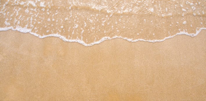 White bubble of Sea wave on fine sand at the beach