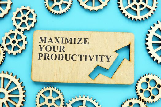 Maximize Your Productivity phrase on the wooden plate and gears.
