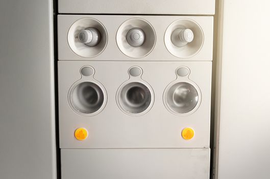Adjustable lights and air conditioners overhead seat controls of a commercial aircraft. Closed air conditioners nozzles