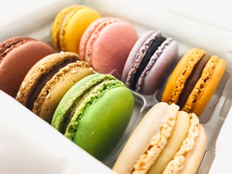 a group of colorful macarons stacked in a plastic package. Meringue-based dessert