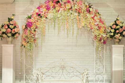 Wedding arch with flowers for the wedding ceremony. Wedding flower background