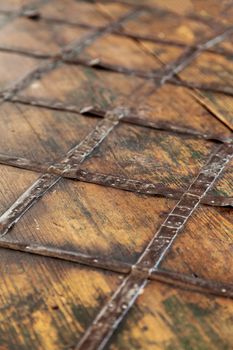 Fragment of an old brown wooden chest. Wood and forged metal on the chest cover.