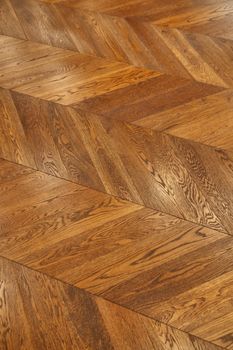 Fragment of brown wooden parquet floor. Wooden background.