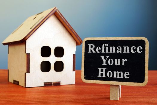 Refinance Your Home mortgage board and wooden house.
