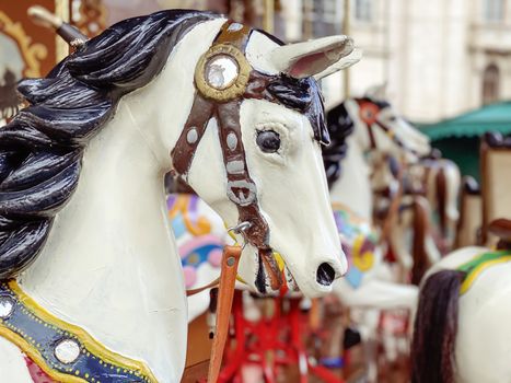 close-up of a white horse of an ancient carousel. Fun and play. Childhood and traditions