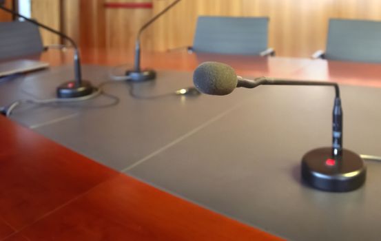 microphone on a wooden table of a boardroom. Business concept