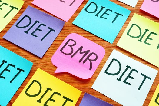 BMR basal metabolic rate and diet signs on the memo sticks.