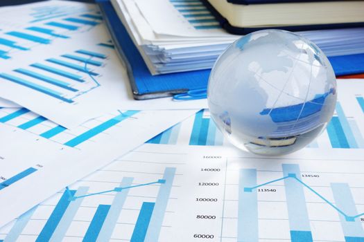 Globe and financial reports as symbol international global business.