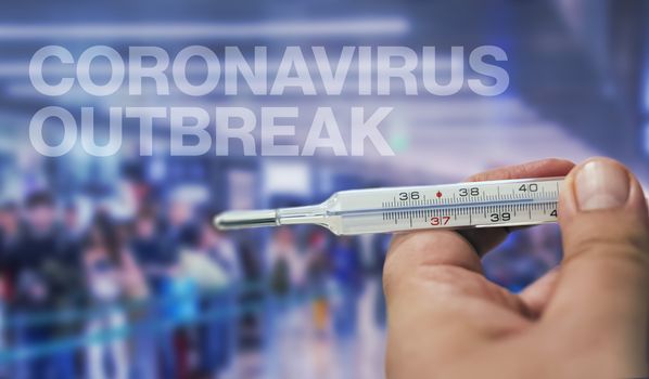 Coronavirus outbreak. Thermometer in a male hand. high body temperature. Temperature measuring by a thermometer. Fever measuring