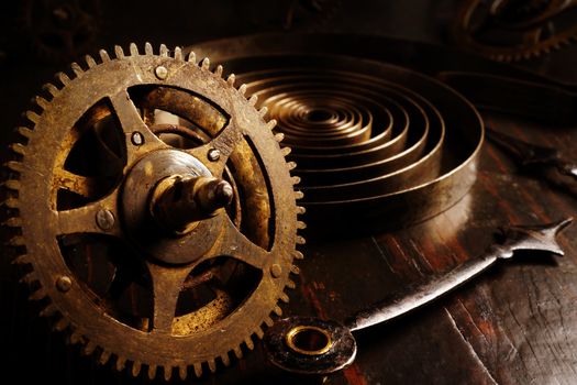 Close up of old watch gears. Dark background with retro clock as time concept.