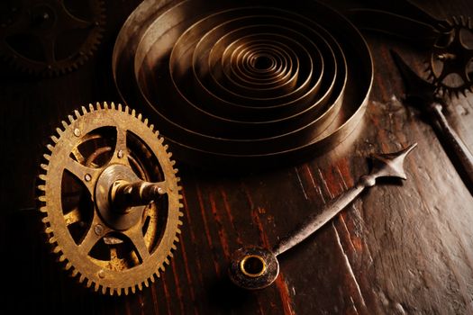 Old watch mechanism parts in the dark. Clock hands as symbol of time management.