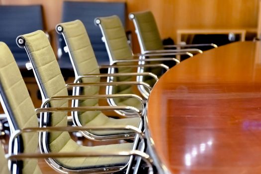 a group of empty chairs lined up in front of a boardroom table. Management and company management.