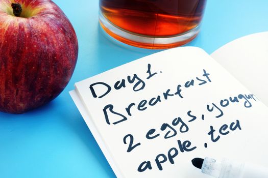 Diet meal plan for one day and apple.