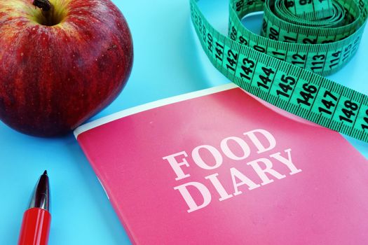 Food diary for weight loss with diet and apple.
