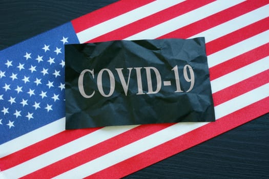 USA flag and covid-19 coronavirus sign as symbol of epidemic.