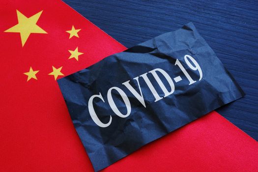 China flag and covid 19 coronavirus sign as symbol of wuhan chinese flu.