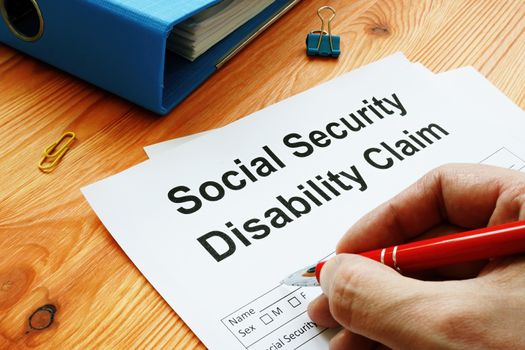 Man filling in Social Security Disability Claim.