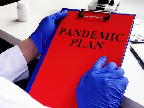 Doctor is reading pandemic plan for preparedness.