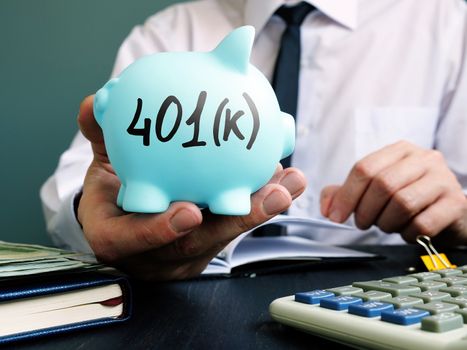 Man proposes piggy bank with sign 401k. Retirement pension plan.