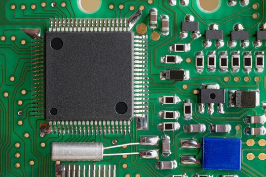 PCB board supermacro close-up. Many capacitors, resistors on board. Digital engineering photo. Flash microprocessor on photo. 