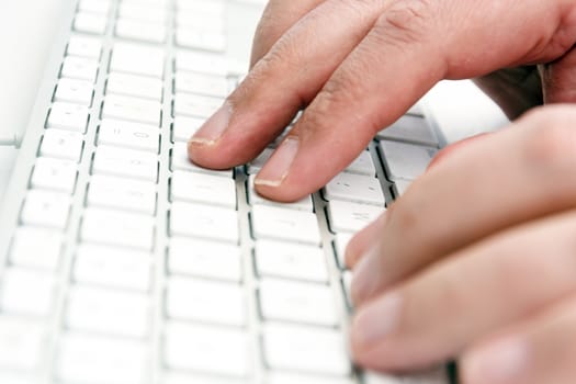 male hands typing keys on a white computer keyboard in an office. Technology and work.