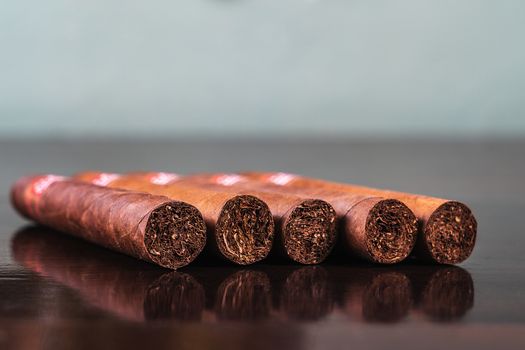 A close up of five cuban cigars on table