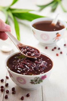 A bowl of homemade red bean soup with a spoon