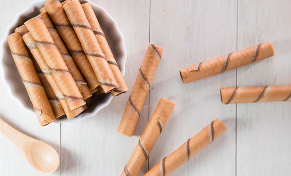 Chocolate wafer roll on wooden table