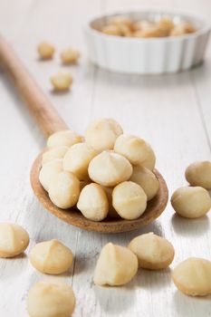 macadamia nuts in wooden spoon