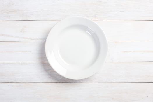 top view of plate on white wooden table