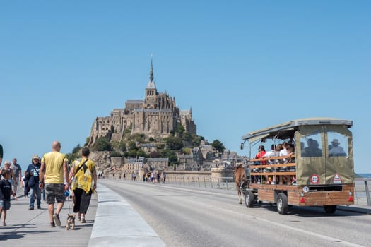 The horse cars called "callèche" in french going to Mont Saint Michel, France 9-9-19 typical and romantic way to visit the place.