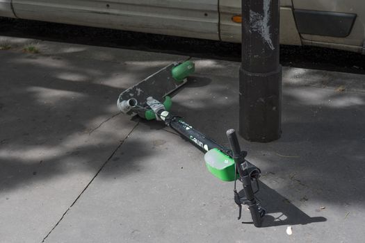 French parisian non ecological lifestyle : short term use objects : Broken electric scooter on the road in Paris, France 11-9-19