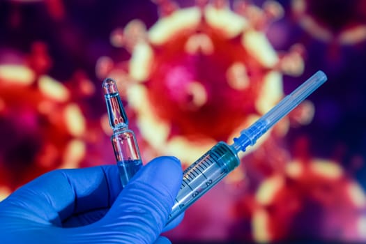 Coronavirus vaccine. A hand in medical gloves holds a vaccine and a syringe against the background of the image of a coronavirus. covid-19,