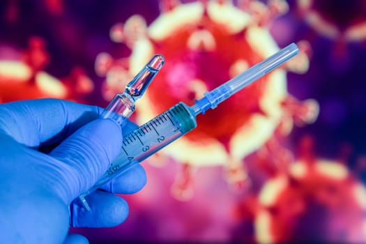 Coronavirus vaccine. A hand in medical gloves holds a vaccine and a syringe against the background of the image of a coronavirus. covid-19,