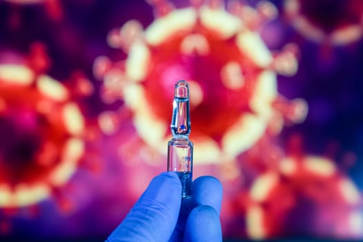 Coronavirus vaccine. A hand in medical gloves holds a vaccine and a syringe against the background of the image of a coronavirus. covid-19,