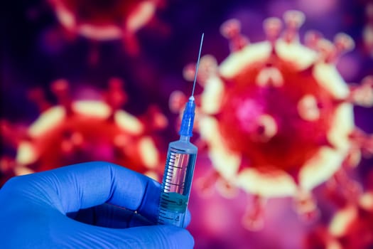 Coronavirus vaccine. A hand in medical gloves holds a vaccine and a syringe against the background of the image of a coronavirus. covid-19,