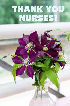 The text of the greeting on the medical holiday-the day of the nurse is written on the background of a beautiful bouquet of flowers. Healthcare and medical concept