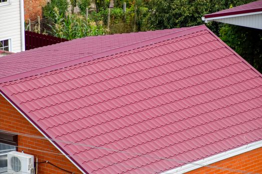 Roof made of metal. Construction with modern roofing materials. Corrugated metal profile.