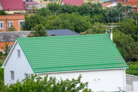 Roof made of metal. Construction with modern roofing materials. Corrugated metal profile.